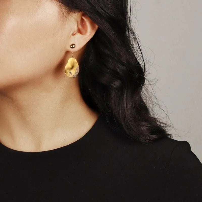 Asymmetric floral earrings with zircon stone detailing in gold-plated silver or gold finish