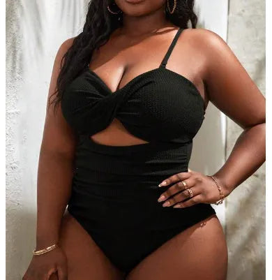 Black plus size one-piece swimsuit on a hanger, showing sleeveless bikini style.