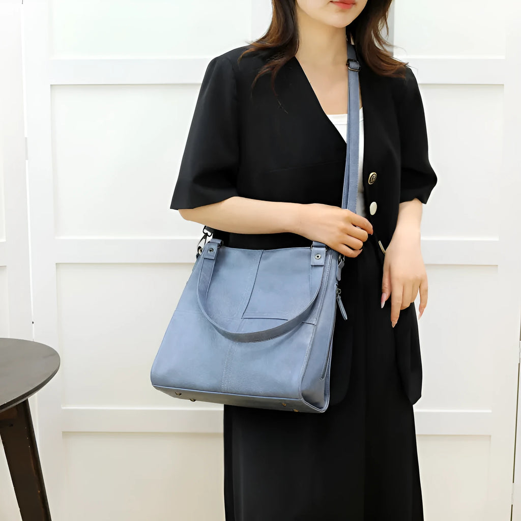 Barrel-shaped crossbody handbag in soft PU leather measuring 30 by 31.5 centimetres