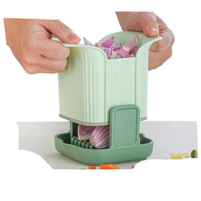 Green manual vegetable chopper with stainless steel blades for slicing potatoes and dicing onions.