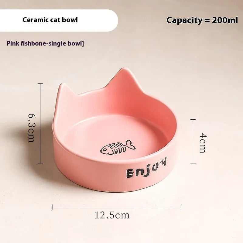 Porcelain cat bowl with cat ear handles in a wooden anti-tumble frame, showing paw print design.