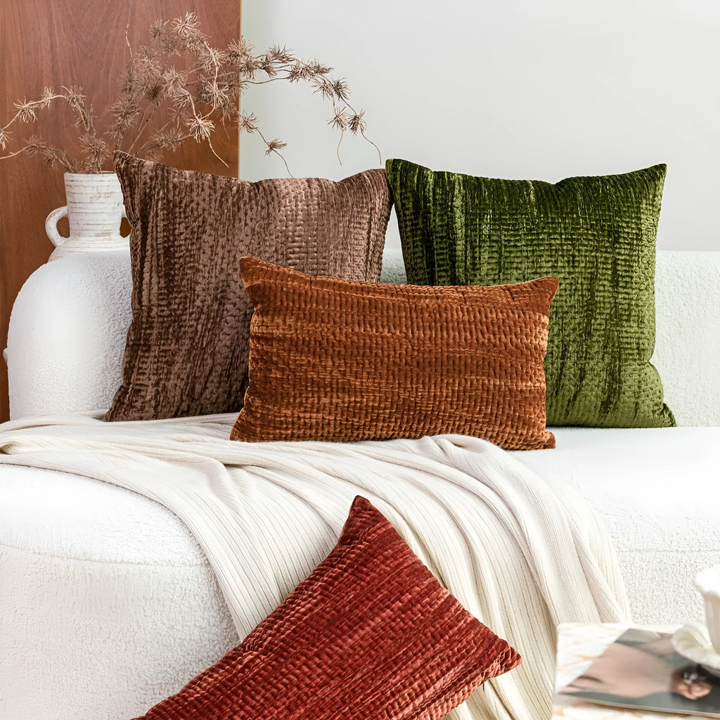 Set of square and waist quilted velvet cushion pillows in green, red, mocha, and orange colours.