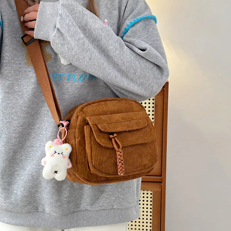 Corduroy crossbody shoulder bag in black with ribbon pendant, horizontal square shape