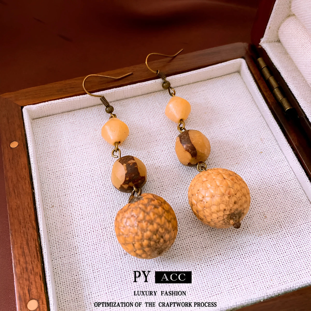 Brown resin fruit core tassel earrings with round geometric design and ear hook clasp for women