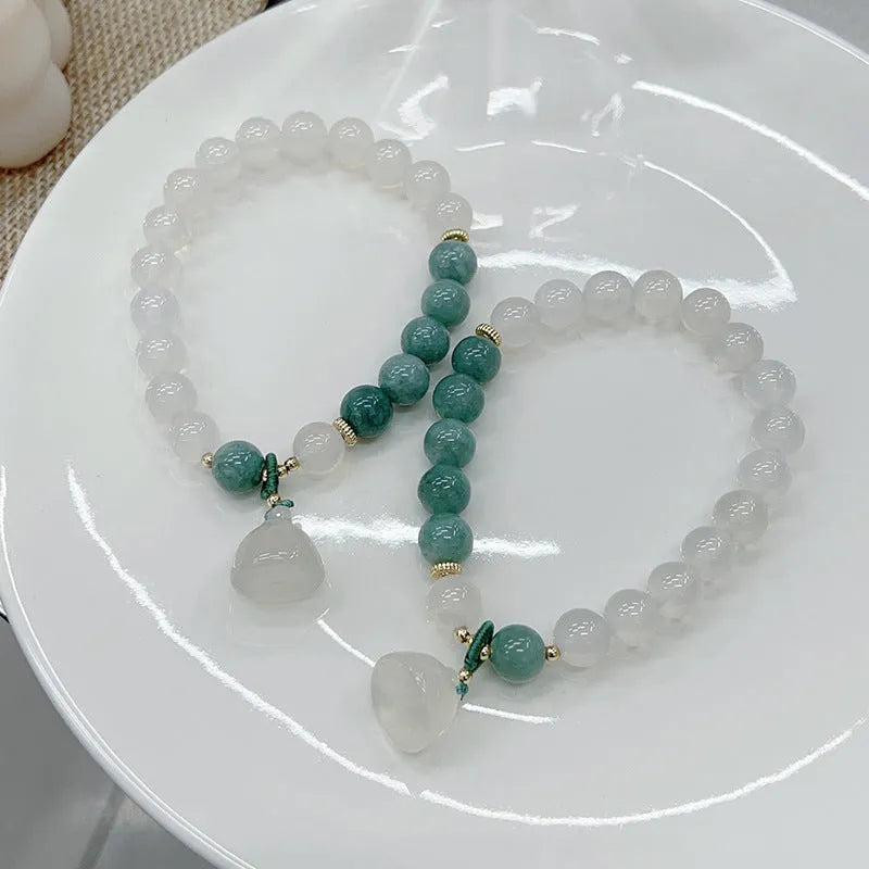 Close-up of a women's retro Chinese style agate bracelet with a lotus seedpod design.