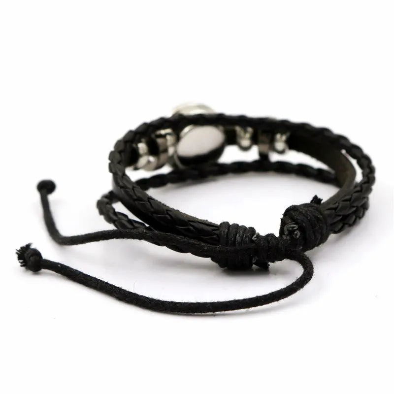 Luminous sun and moon couple leather bracelet on black background, showing glass pattern and adjustable chain