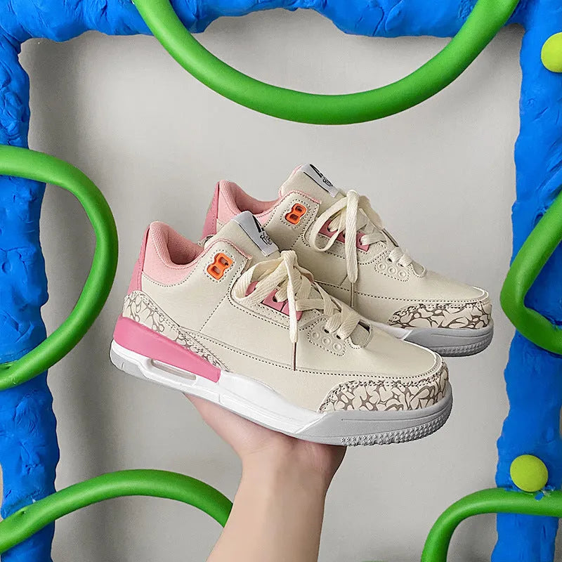 Pink lightweight basketball running shoe with microfiber upper, leather stitching, rubber sole and mesh lining