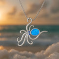 Silver geometric octopus pendant necklace with blue opal inlay on a stainless steel box chain.