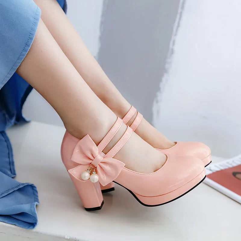 Red waterproof platform shoes with a thick chunky heel, round toe, and buckle fastening on the side.