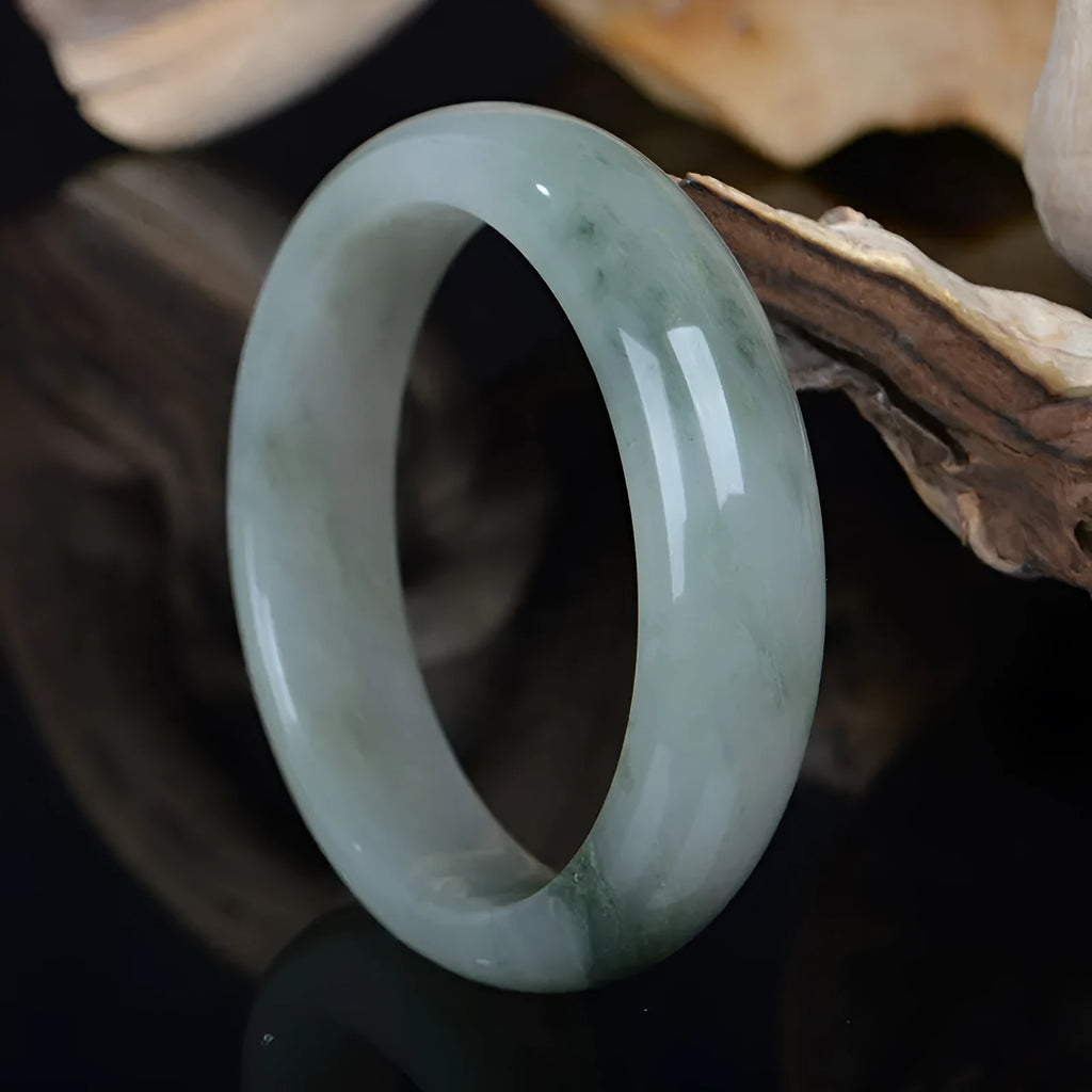 Natural Tianshan Jinsi Jade Chinese style bracelet showing circular form on a plain background.