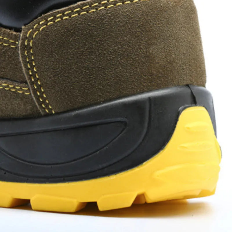 Bronze coloured low-cut cow suede leather safety shoes with a steel toe cap on a work surface.