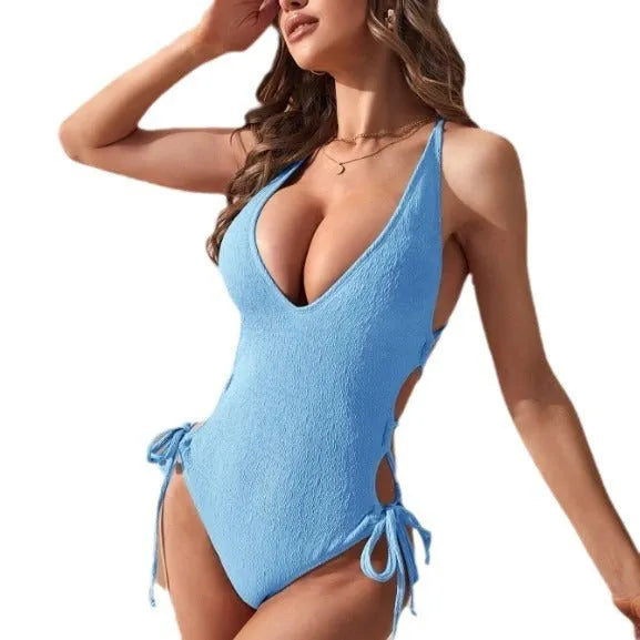 Women's hollow backless one-piece swimsuit with tether detailing in a solid colour.
