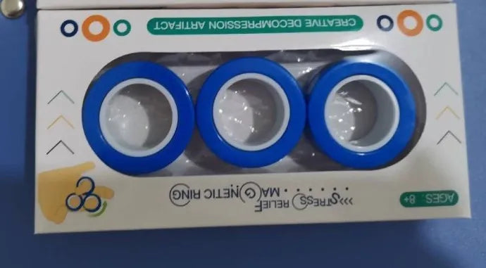 Plastic magnetic finger rotating ring spinner toy shown in multiple colours on a finger.