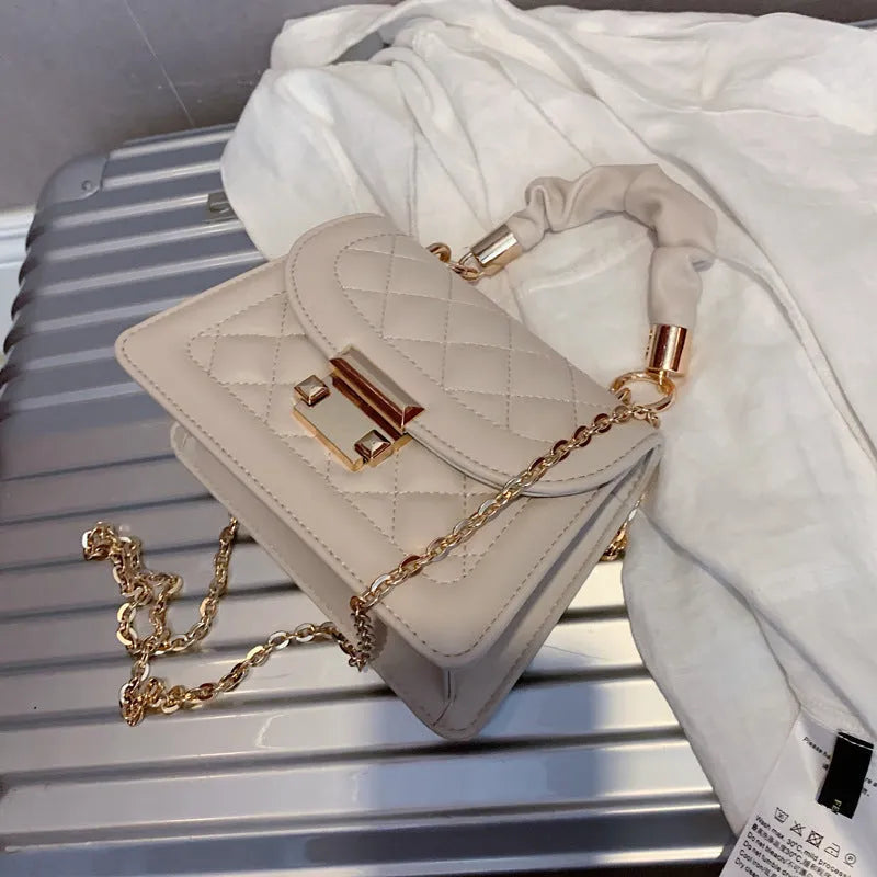 Purple rhombus-shaped small square ladies bag with chain-link shoulder strap on a white background