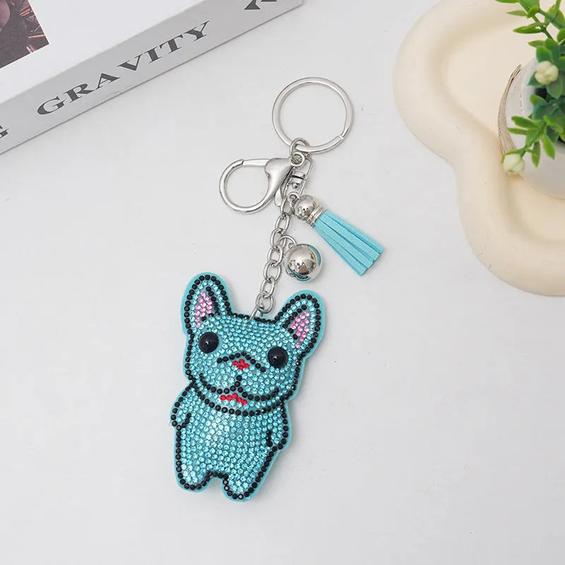Close-up of a sparkling cartoon dog keychain pendant with rhinestones on an alloy base.