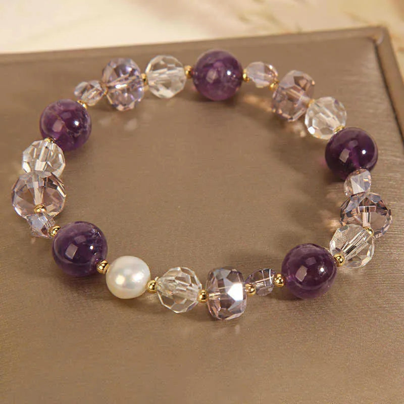 Women's artificial amethyst four-leaf clover bracelet with pearl accents on U-shaped electroplated chain.