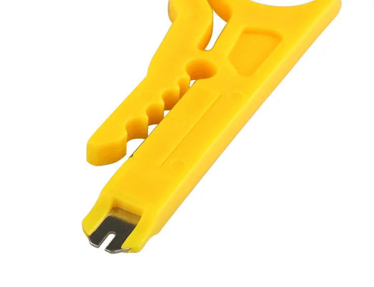 Yellow mini portable wire stripper tool for 0.6mm cables on a workbench.