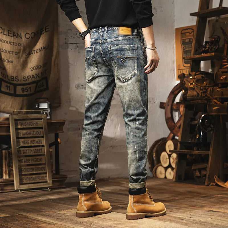 Man wearing vintage blue loose straight-leg jeans with a fleece lining and drawstring waist.