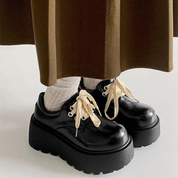 Women's matte black lace-up platform ankle boots with a thick sole and round toe.