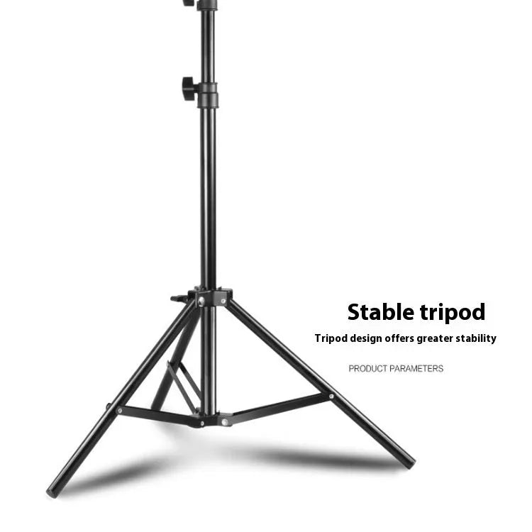 Black mobile phone tripod extended to 1.1m on a desk showing metal legs and phone mount