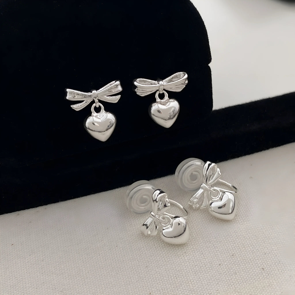 Thick silver-plated copper earrings with heart and bow design, light luxury style for women