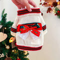 Red and green Christmas dog jumpers with festive print on a small dog model.