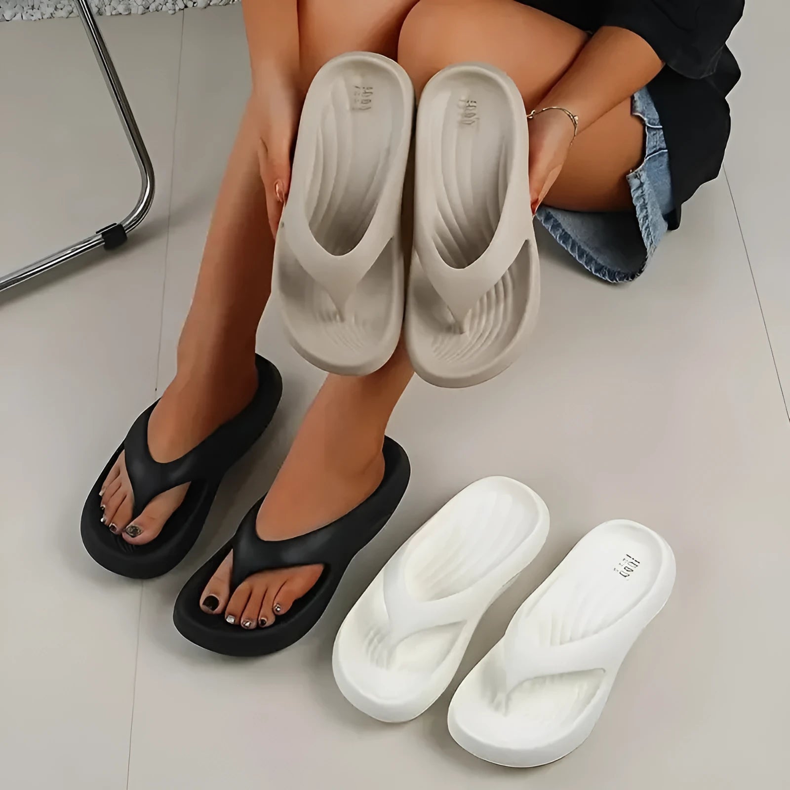 Women's black thick-soled EVA flip-flops with non-slip tread in a paired size format