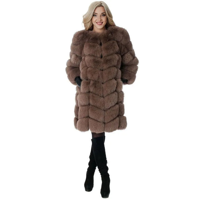 Women's long black artificial fur coat with regular sleeves on a hanger.