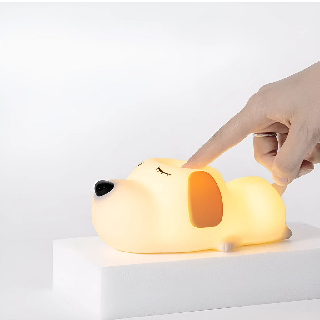 Cute two-colour silicone cartoon dog USB rechargeable night lamp on a surface.