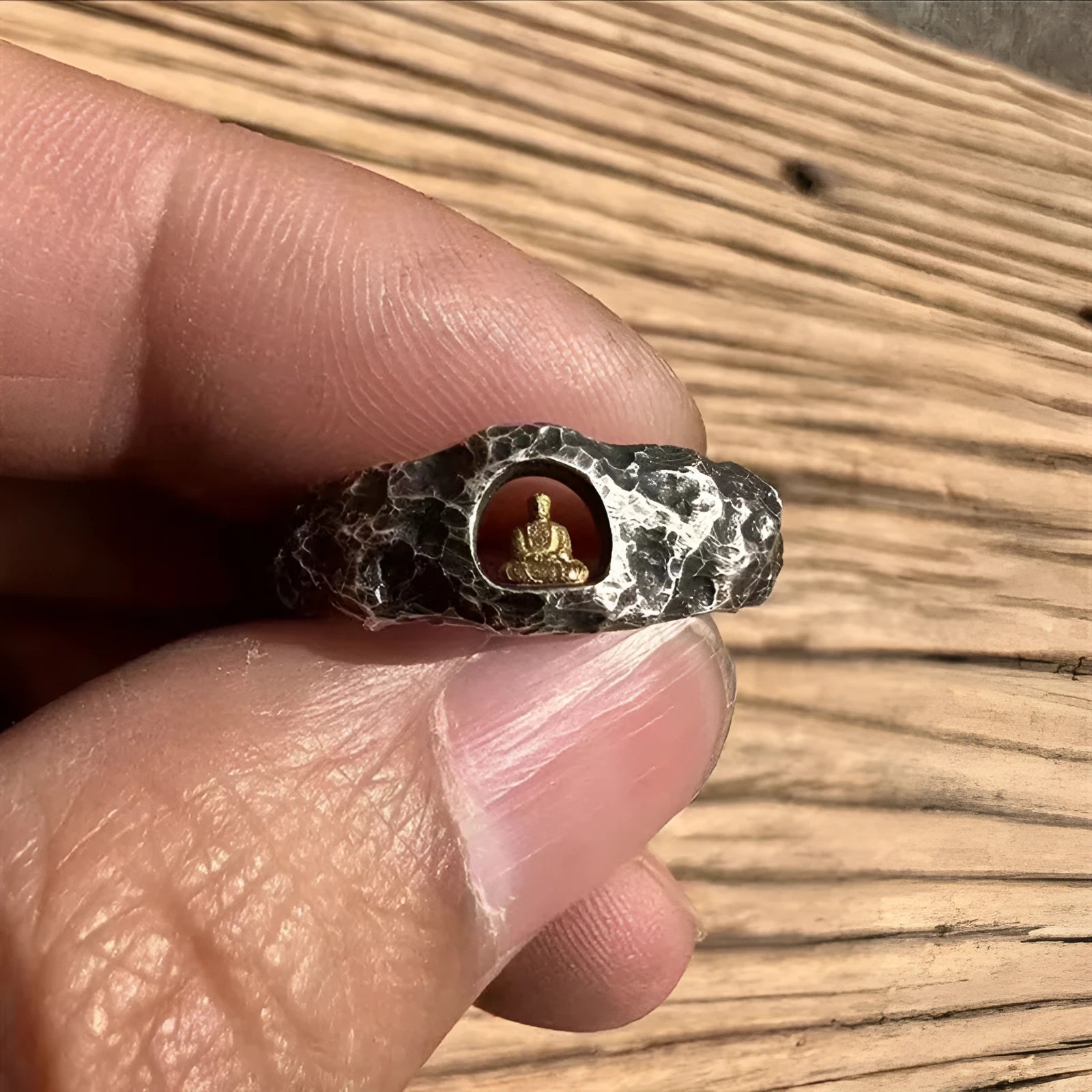 Hand-forged copper Grotto Buddha ring with a rock texture band.