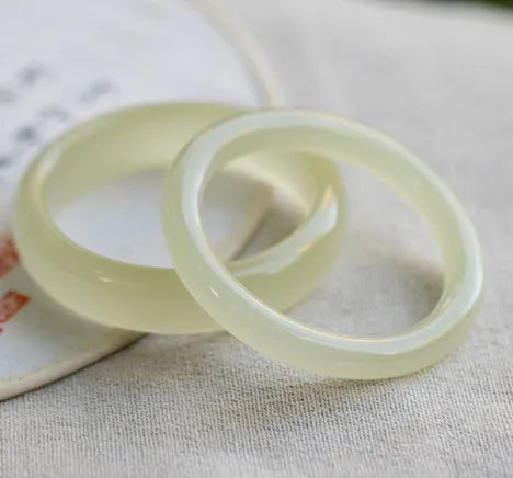 Round bar jade bracelet showing smooth geometric shape and cool stone finish.
