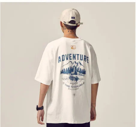 Plus size man modelling a loose fit short-sleeved t-shirt in black, dark grey, or white.