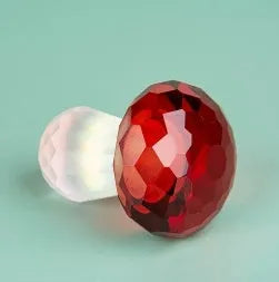 Colourful white crystal mushroom decorative craft in modern geometric style on a desk.