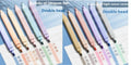 Set of double-ended fluorescent marking pens in assorted bright colours on a white background