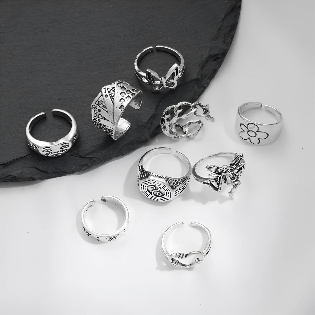 Geometric alloy ring with butterfly and snake motifs in retro style on finger