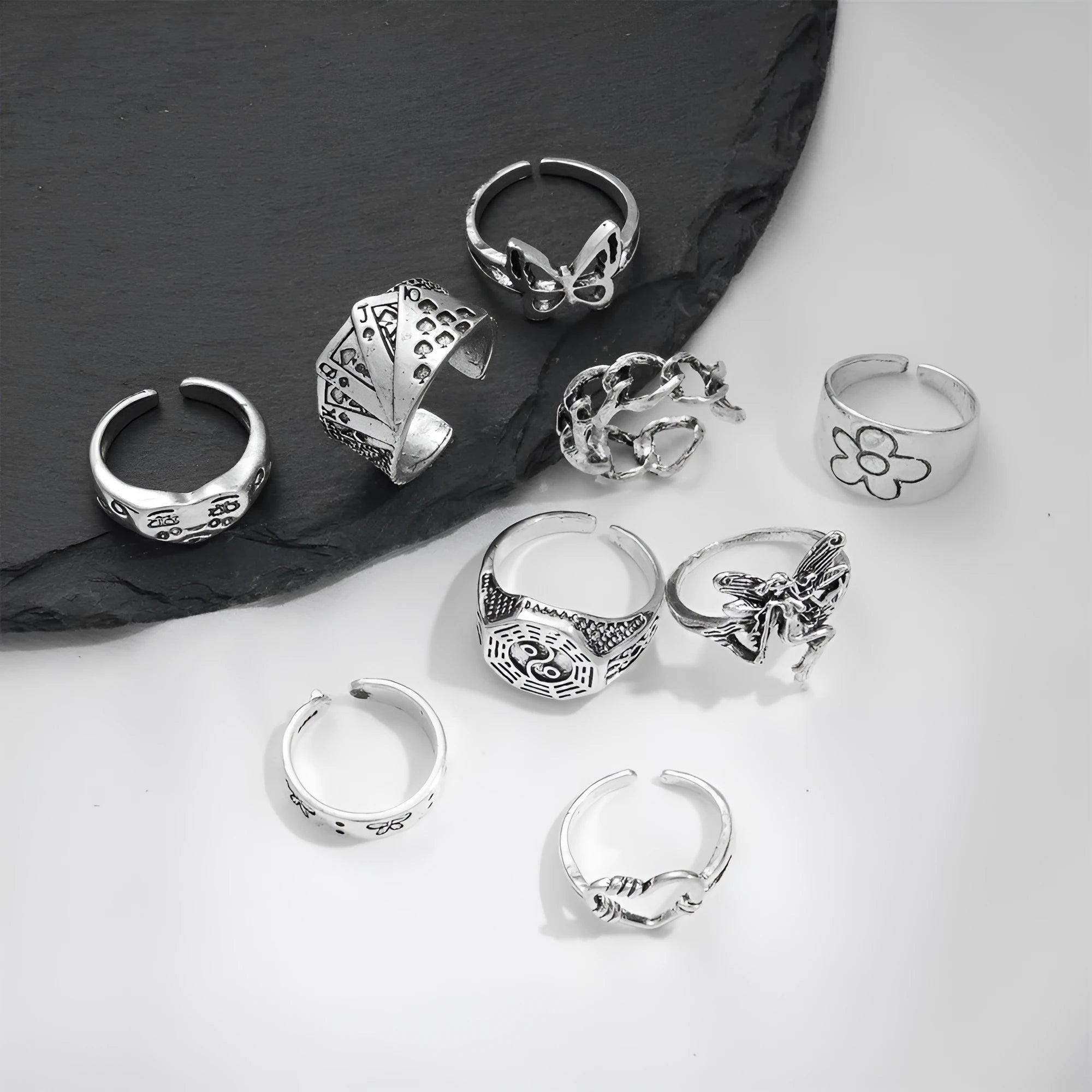 Geometric alloy ring with butterfly and snake motifs in retro style on finger