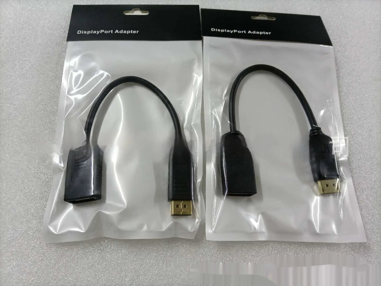 Black DisplayPort DP male to female extension cable with rotating busbar, approximately 10cm long