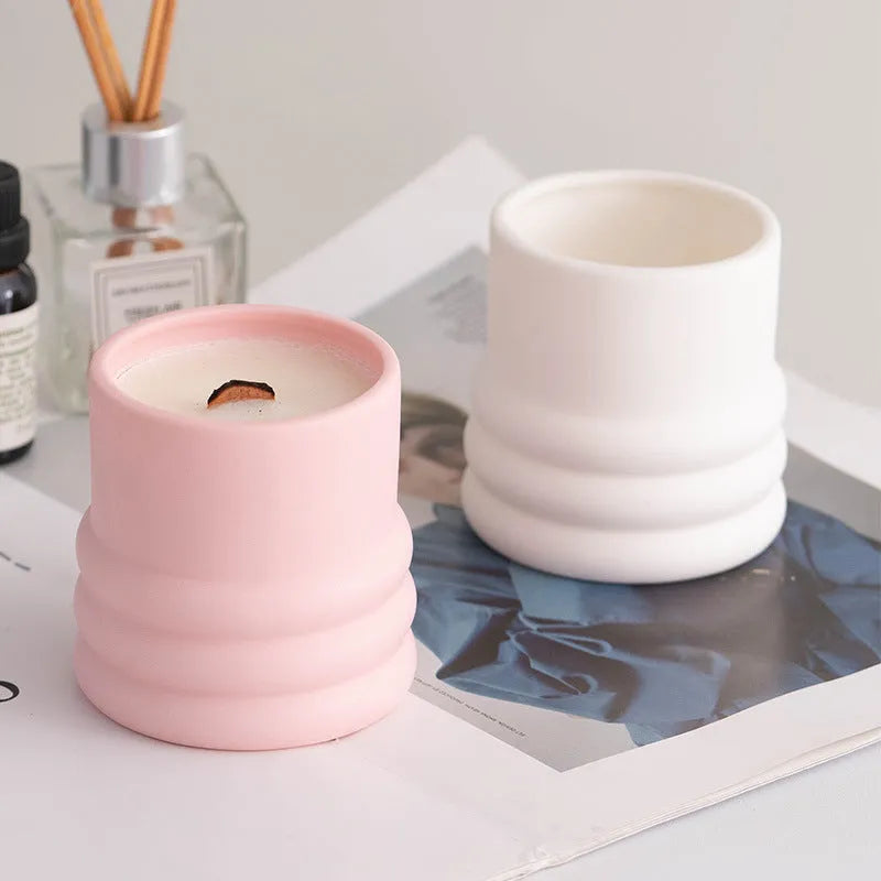 Ceramic candlestick with minimalist relief pattern on a dining table
