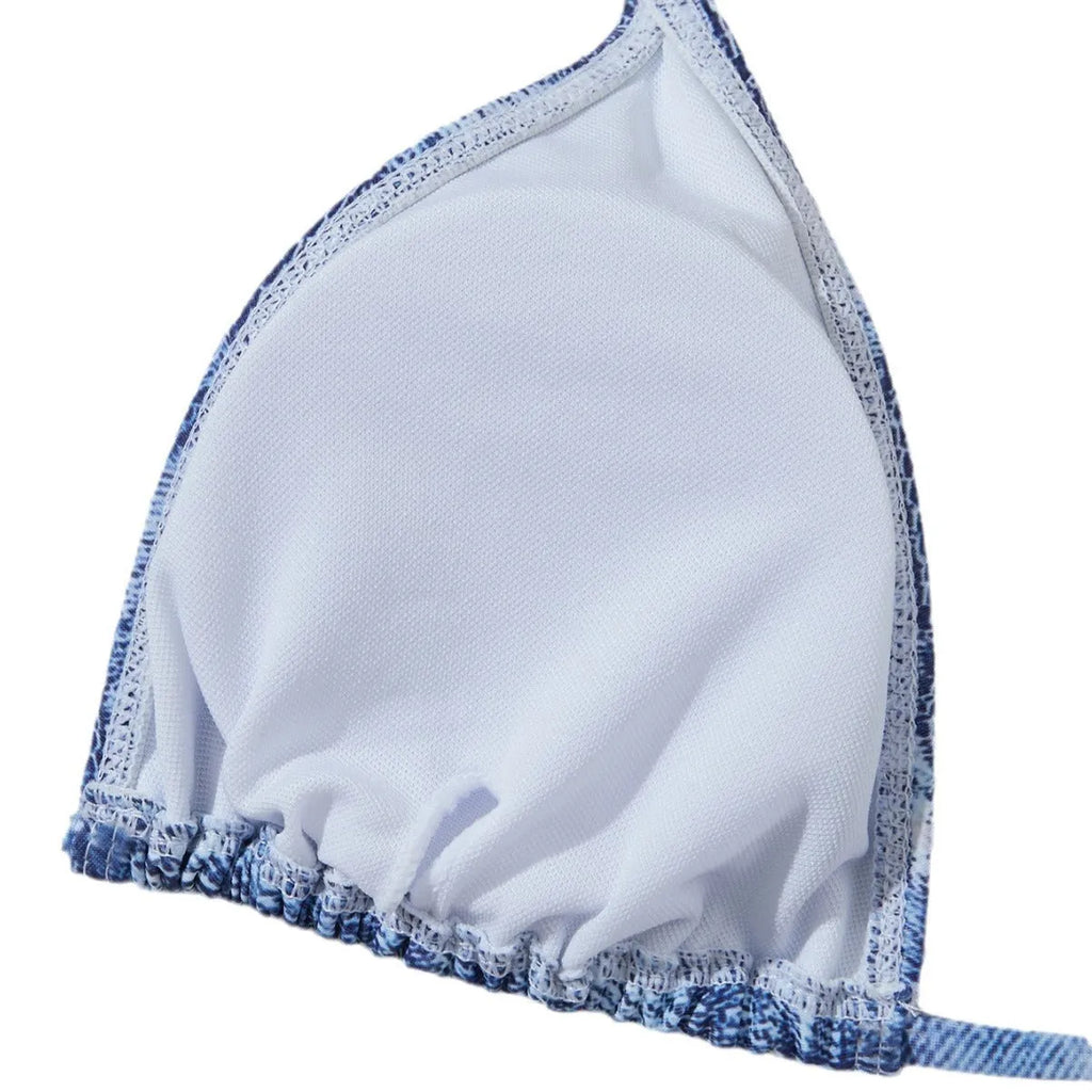 Denim blue printed women's bikini swimsuit with adjustable straps laid flat.