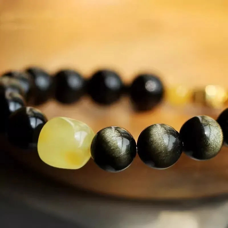 Natural golden obsidian bracelet with geometric zodiac charm bead showing chicken zodiac design