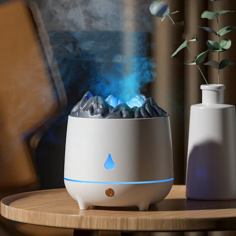 White volcano-shaped USB humidifier emitting mist on a wooden desk