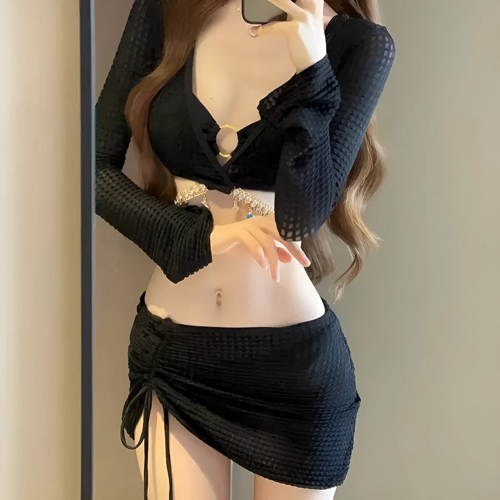 Women's long sleeve bikini swimsuit in black or white colours for swimming activities
