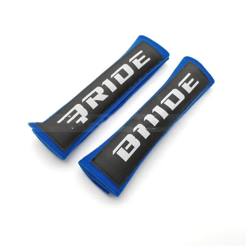 Pair of black car safety belt shoulder pads showing sponge cloth padding and embroidery detail