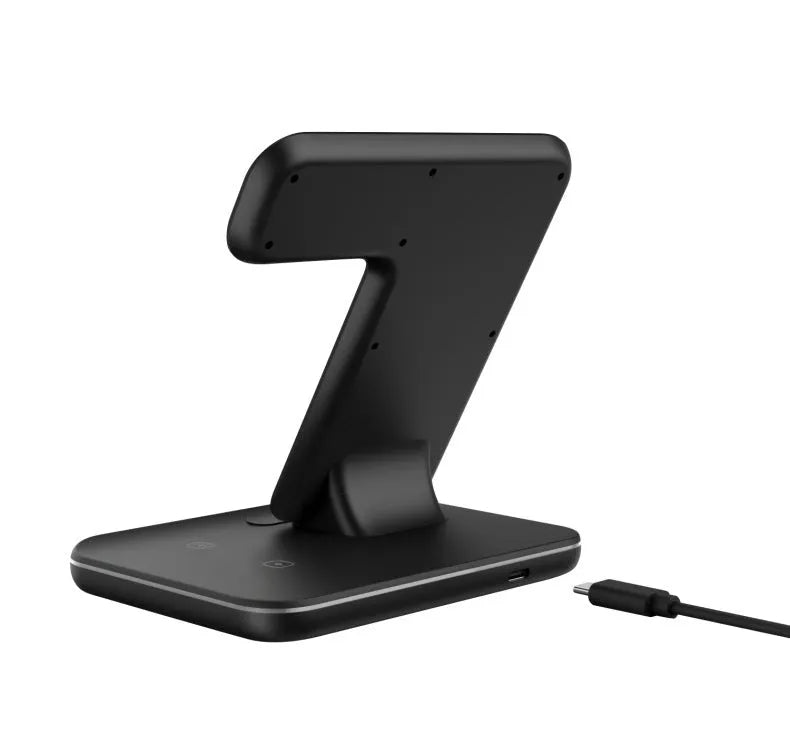 White three-device wireless charging stand on desktop with phone, watch, and headset charging simultaneously