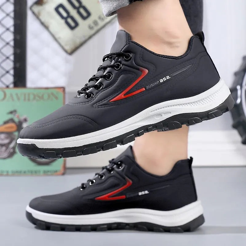 Black and grey waterproof leisure sports shoes with artificial PU upper and lace-up closure on a flat heel.