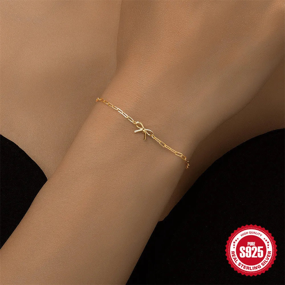 S925 sterling silver bracelet with geometric heart charm and clip chain fastening in gold plating