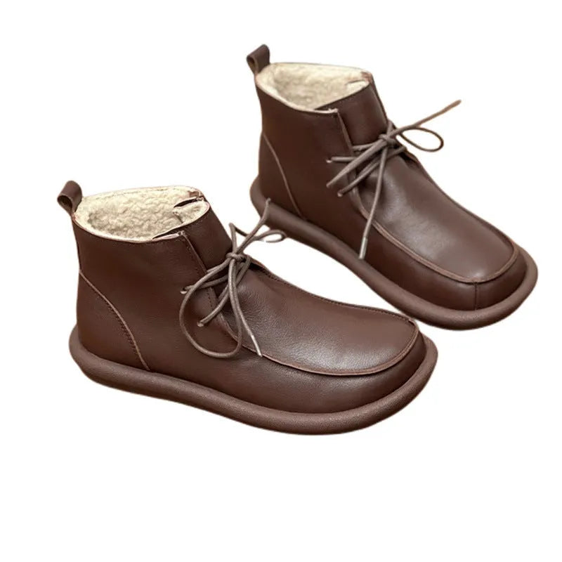 Women's black cowhide ankle boots with flat heel and round toe, showing 9cm sock height