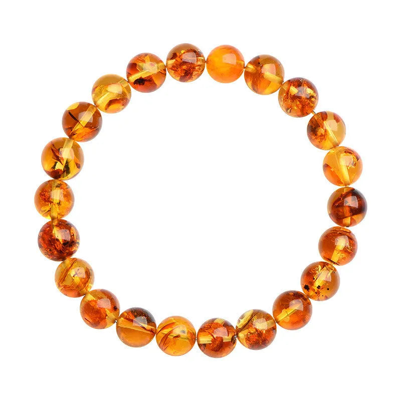 Natural yellow piebald amber geometric bracelet on a wrist, showing polished beads with flower spot patterning.