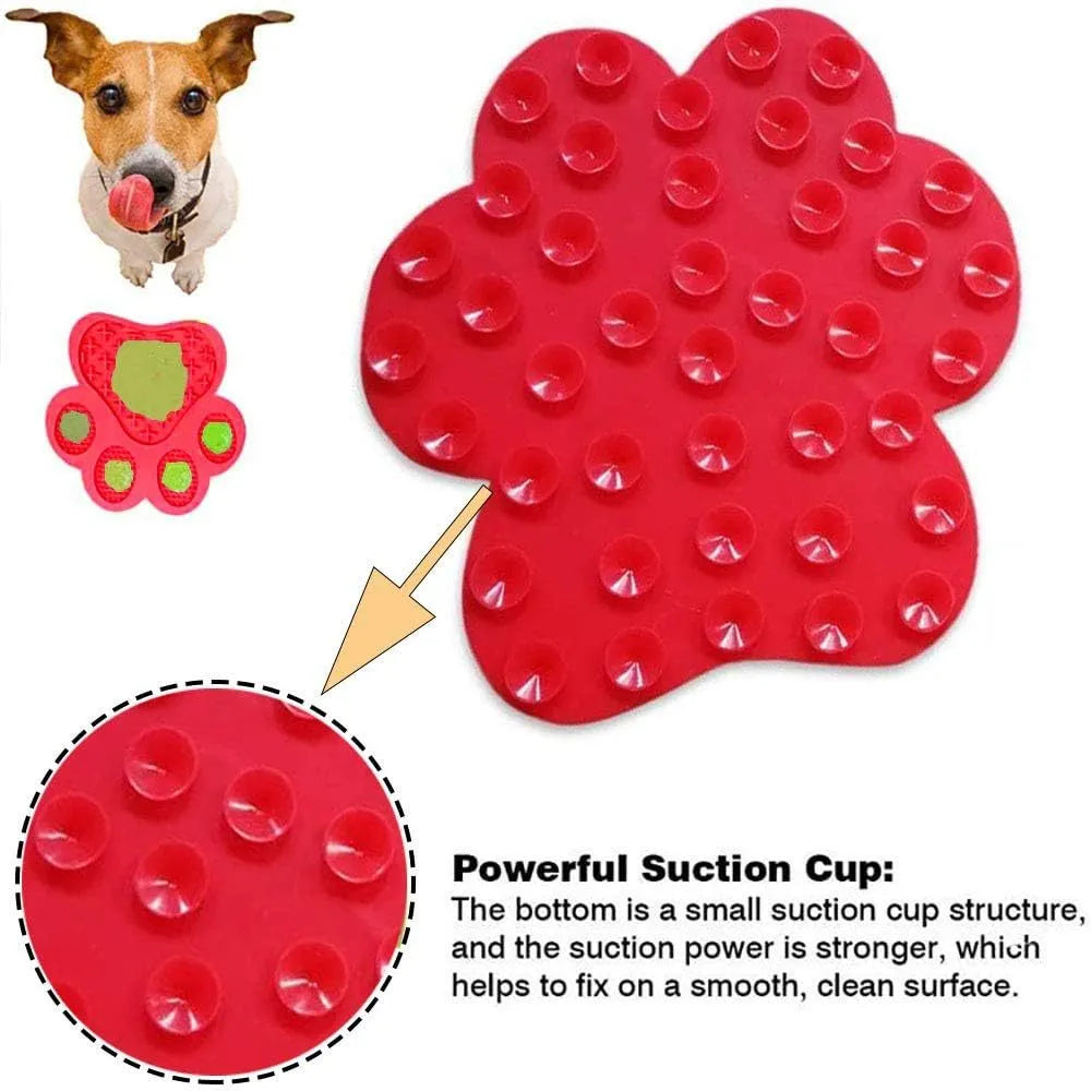 Blue bone-shaped silicone dog licking mat with suction cups on the back, placed on a tiled wall.