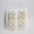 Dovetail bow hairclips for children in multiple colour patterns including beige grid dots and blue flowers